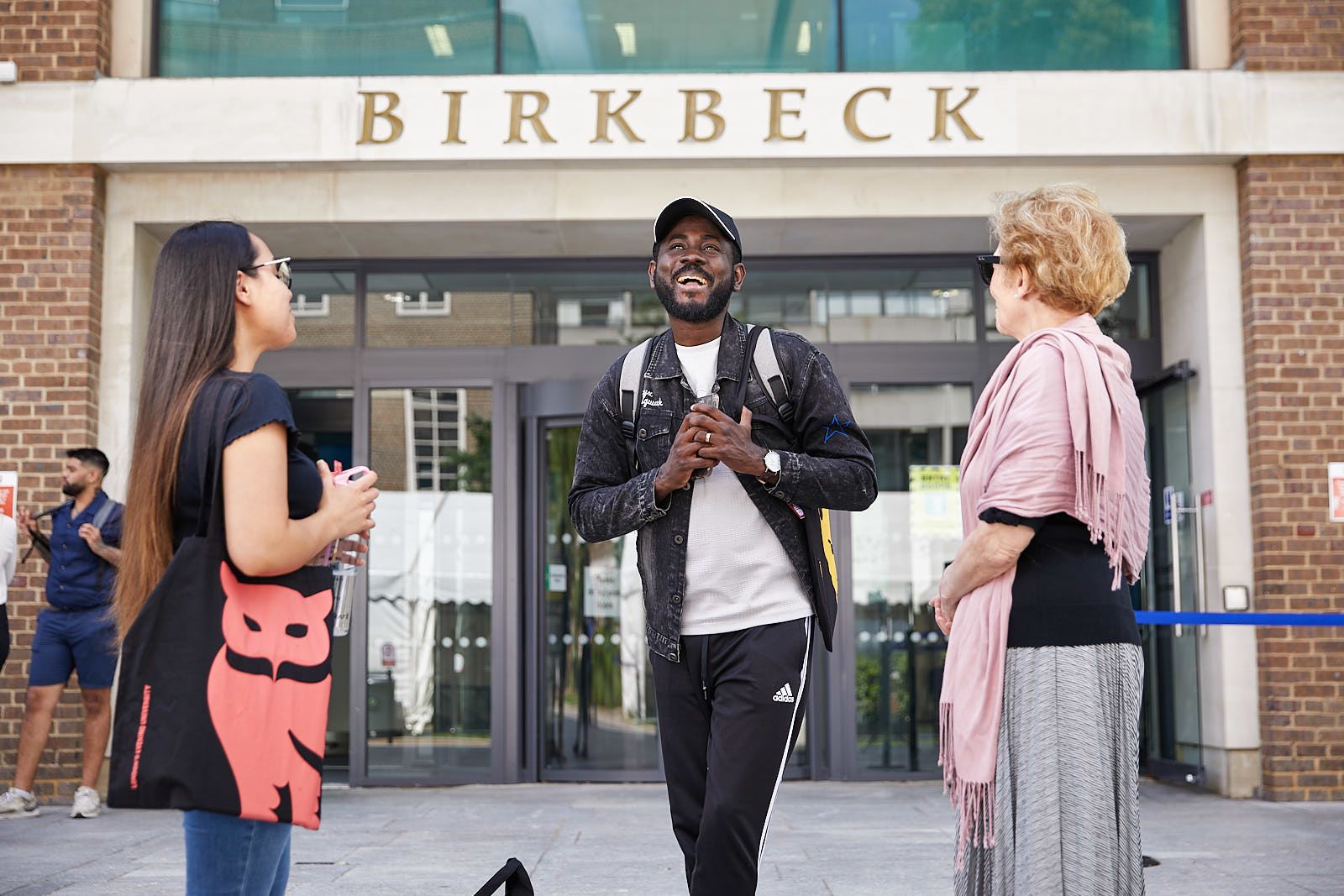 Birkbeck students outside the main Malet Street building, laughing and smiling